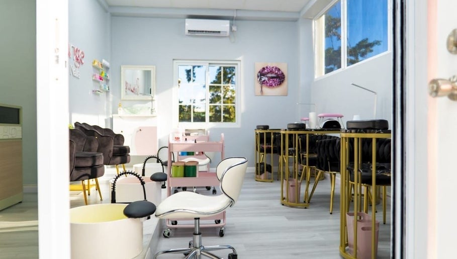 Elegant interior of Belle Lounge Spa in Saint George, Saint George, GD with plush seating and nail stations.