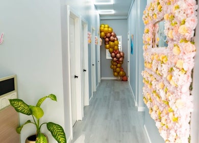 Elegant hallway at Belle Lounge Spa, Saint George, GD featuring floral decor and elegant modern design.