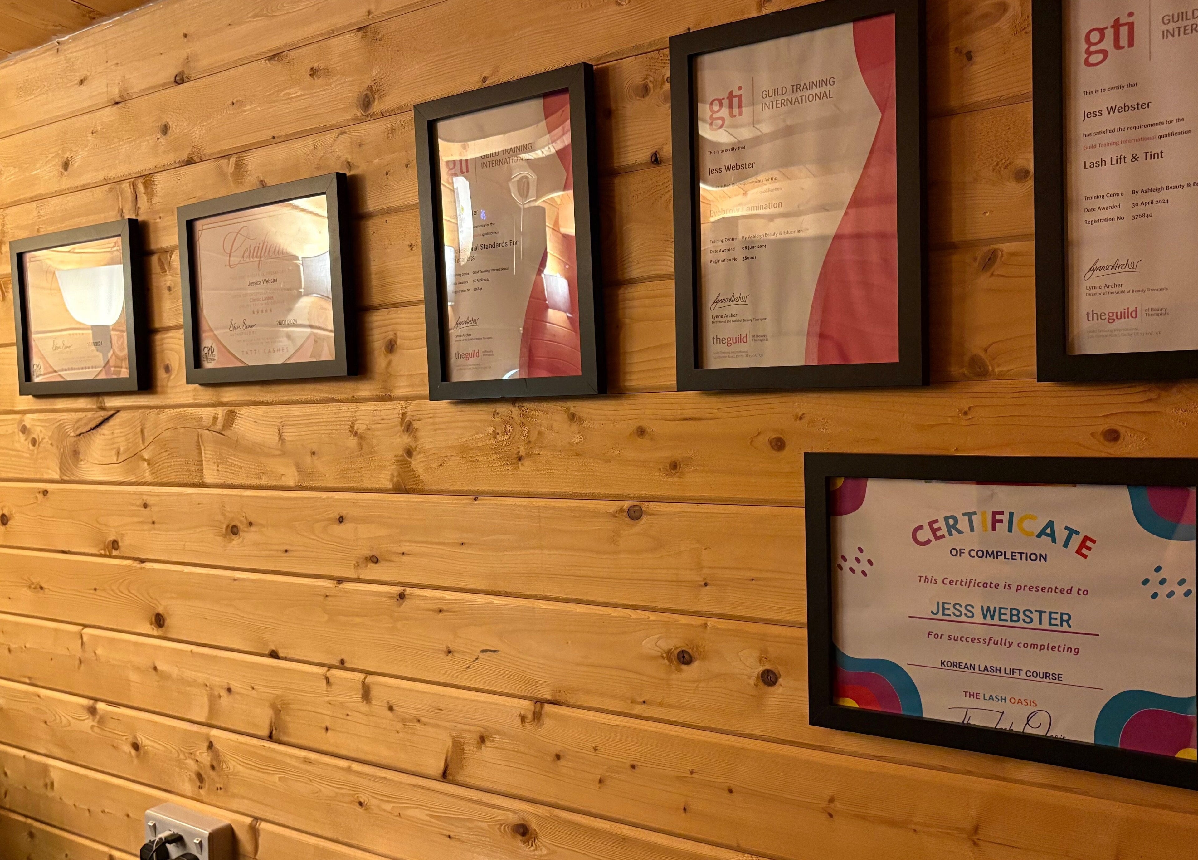 Certificates of Jess Webster at Beauty by Jess Web, Nuneaton, United Kingdom, GB on a wooden wall.