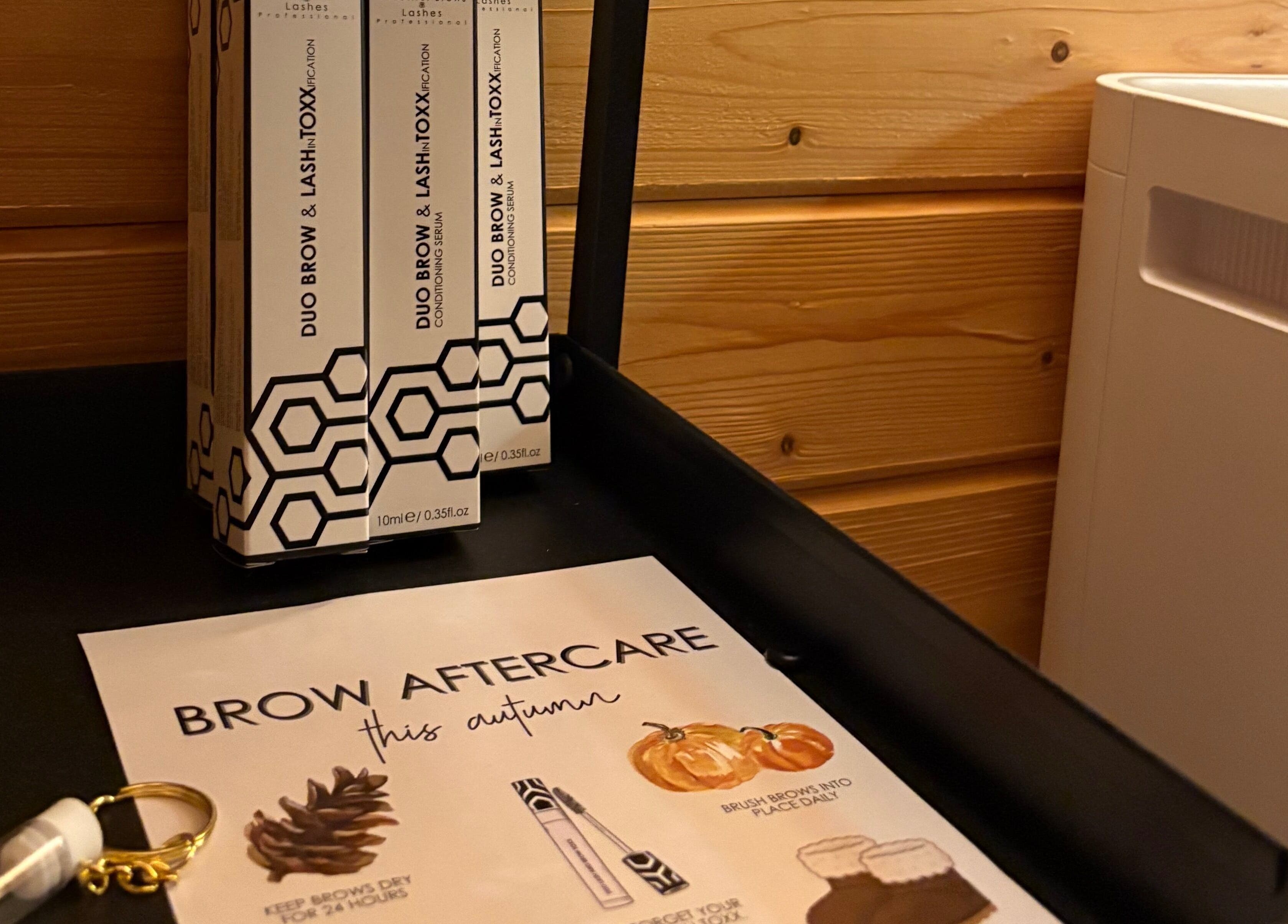 Brow care products at Beauty by Jess Web, Nuneaton, United Kingdom, GB, elegantly displayed on a rustic shelf.