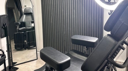 Modern black tattoo chair and mirror at Finelines by Fern Tattoo, Wickford, England, GB.