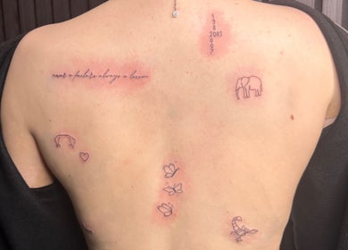 Back with minimalist tattoos at Finelines by Fern Tattoo, Wickford, England, GB showcasing delicate designs.