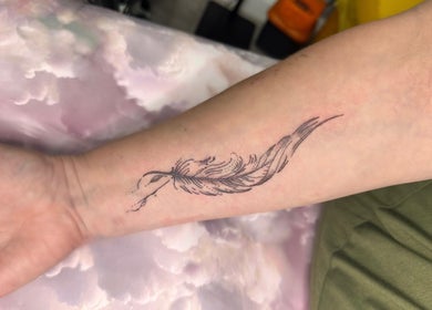 Intricate feather tattoo on forearm by Finelines by Fern Tattoo in Wickford, England, GB.
