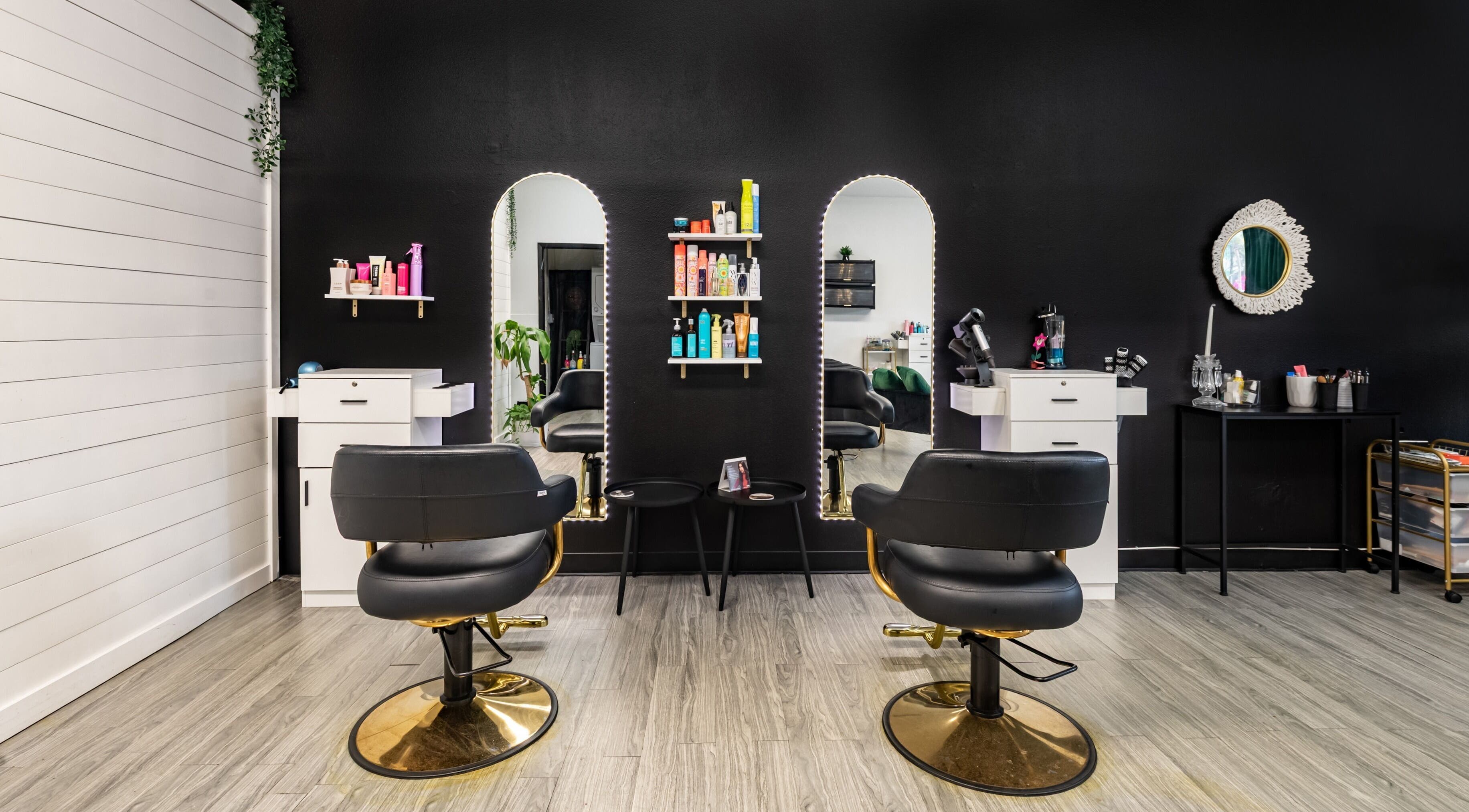 YK Beauty Salon's sleek styling area in Bradenton, Florida, US with modern chairs and illuminated mirrors.