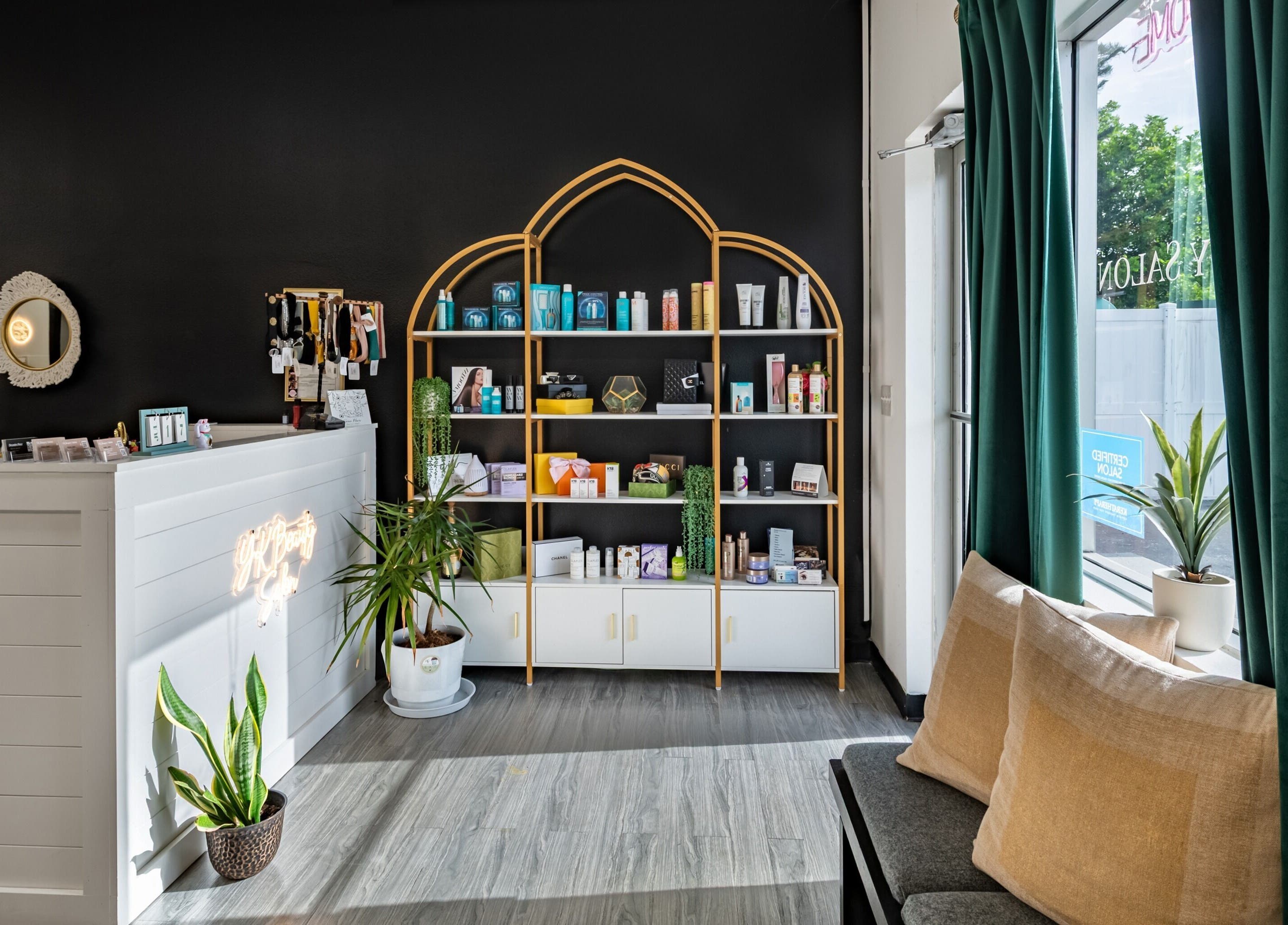 Reception area of YK Beauty Salon in Bradenton, Florida, US featuring a stylish product display and cozy seating.