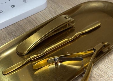 Elegant gold manicure tools on a tray at BeautyByErica, Youghal, County Cork, IE.