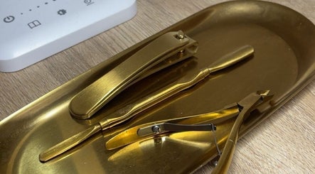 Elegant gold manicure tools on a tray at BeautyByErica, Youghal, County Cork, IE.