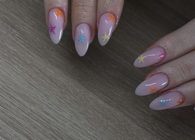 Colorful star nail art at BeautyByErica in Youghal, County Cork, IE. Features vibrant star patterns on nails.