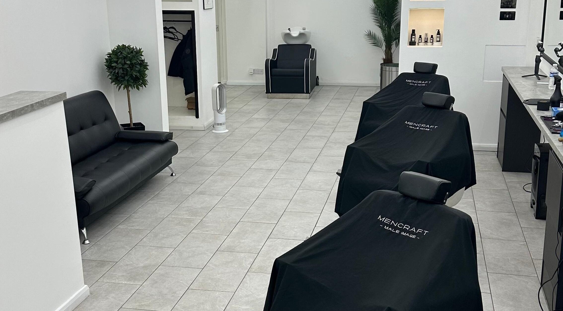 Modern interior of Mencraft, a beauty venue in Brighton And Hove, England, GB, featuring sleek chairs and decor.