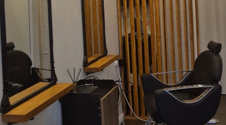 Modern styling chair at Lela's Hair Lounge, Weston-super-Mare, England, GB, featuring elegant mirrors.