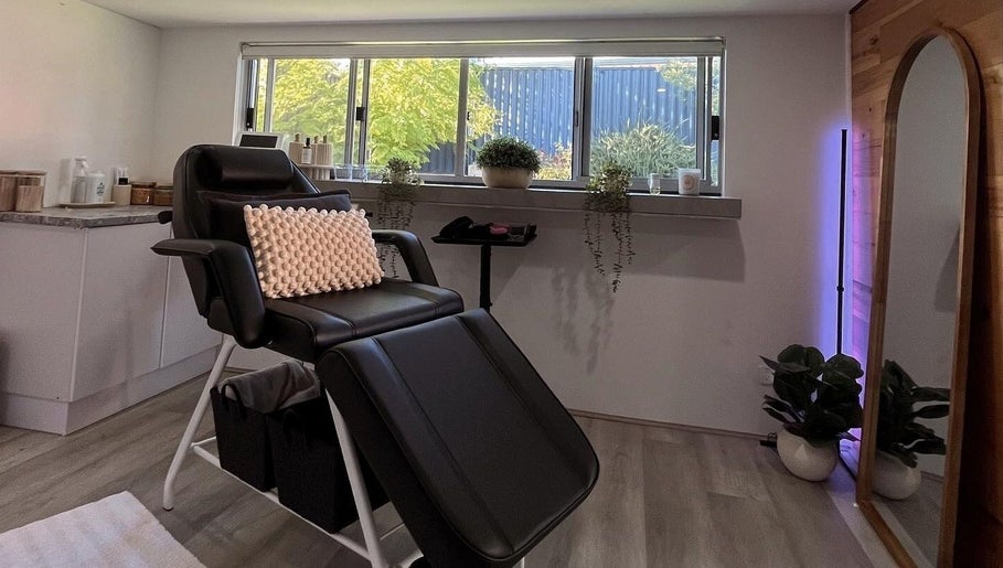 Relaxing treatment room at CSM Studios, Padbury, Western Australia, AU, featuring a comfortable black chair.