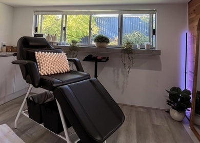 Relaxing treatment room at CSM Studios, Padbury, Western Australia, AU, featuring a comfortable black chair.