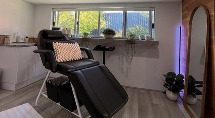Relaxing treatment room at CSM Studios, Padbury, Western Australia, AU, featuring a comfortable black chair.