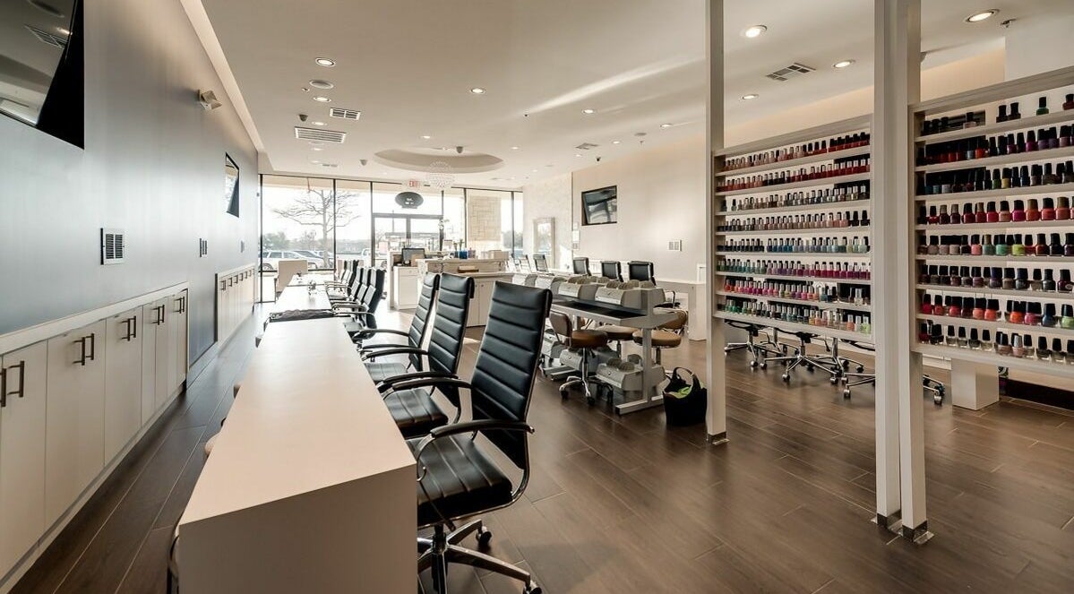 Modern nail salon interior at Nail Lounge, Allen, Texas, US, showcasing sleek design and vast polish selection.