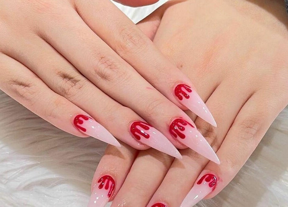 Stylish red and white nail art at Nail Lounge, Allen, Texas, US showcasing creativity and elegance.