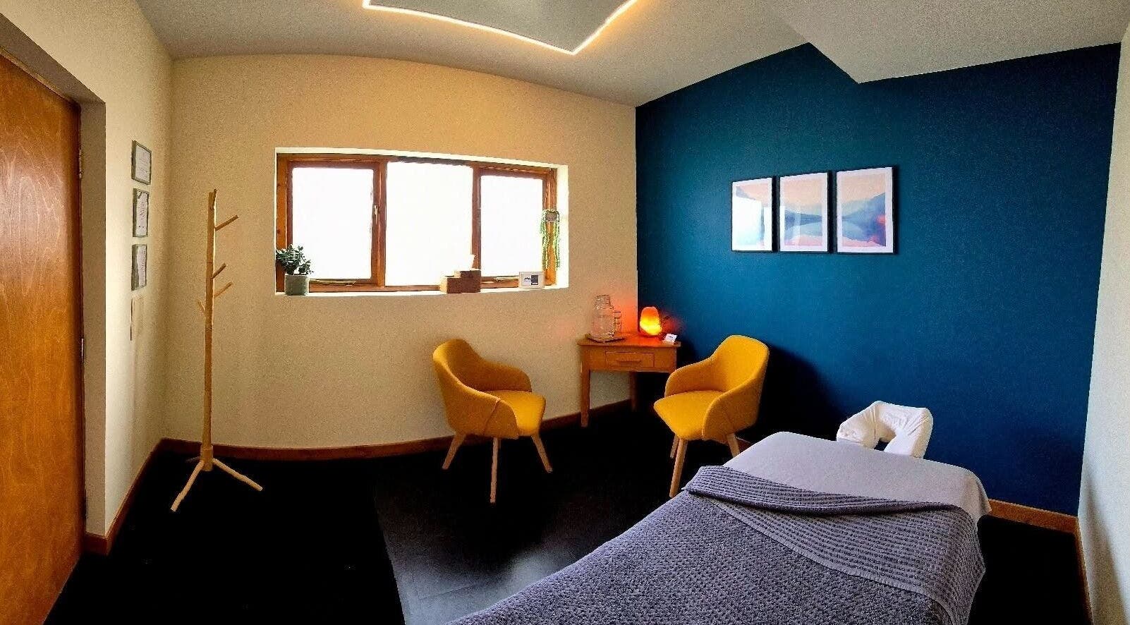 Calm massage room at Elevate Massage Aberdeen, Scotland, GB featuring cozy chairs and soft lighting.