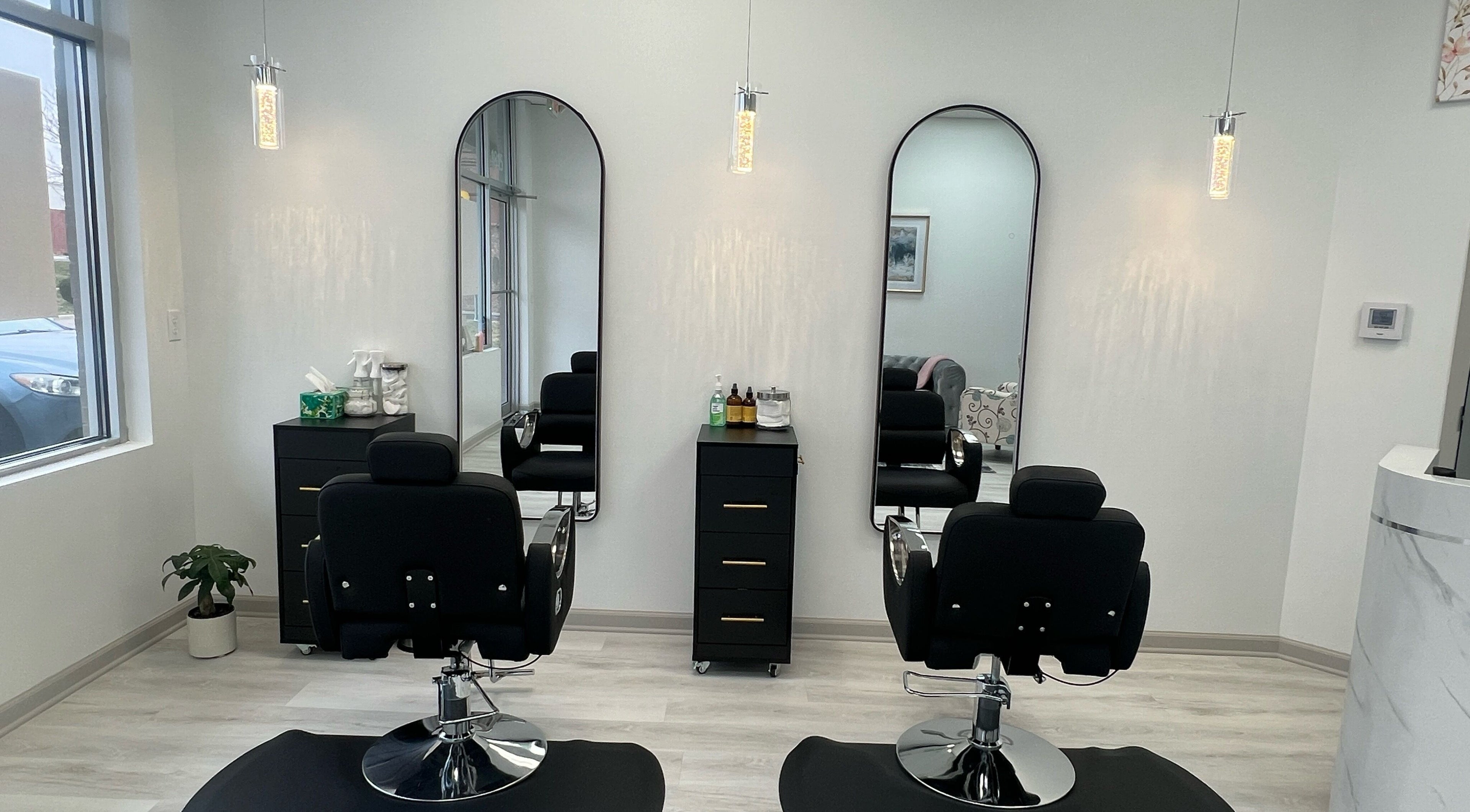 Chic salon interior with mirrors and black styling chairs at Skin Glow KC, Gardner, Kansas, US.