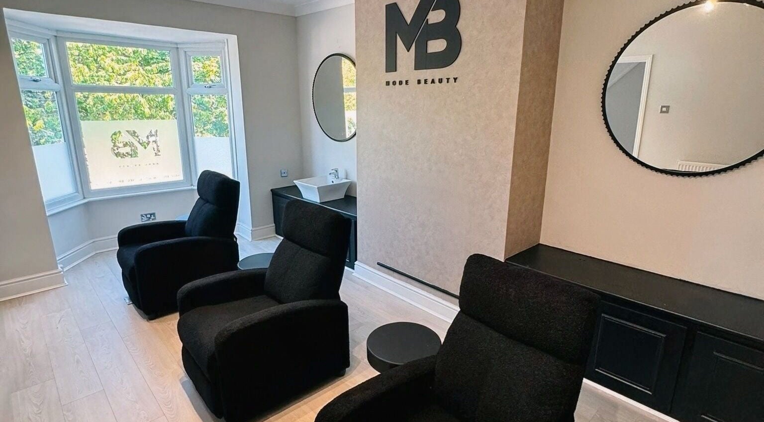Chic interior of Mode Beauty in Sheffield, England, GB with modern chairs and stylish decor.
