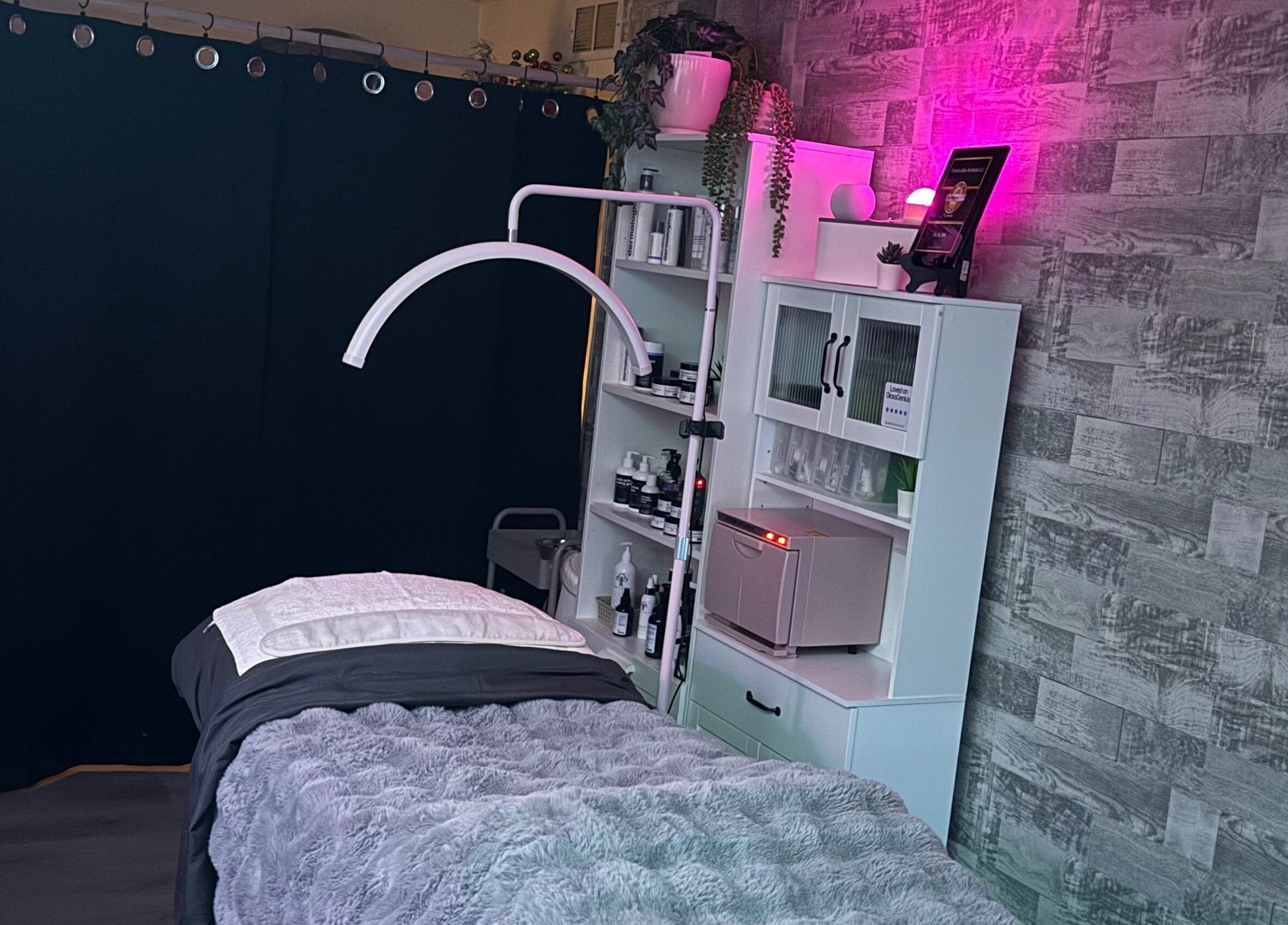 Relaxing treatment room at Timeless Glow Aesthetics, Kenosha, Wisconsin, US with ambient lighting and cozy decor.