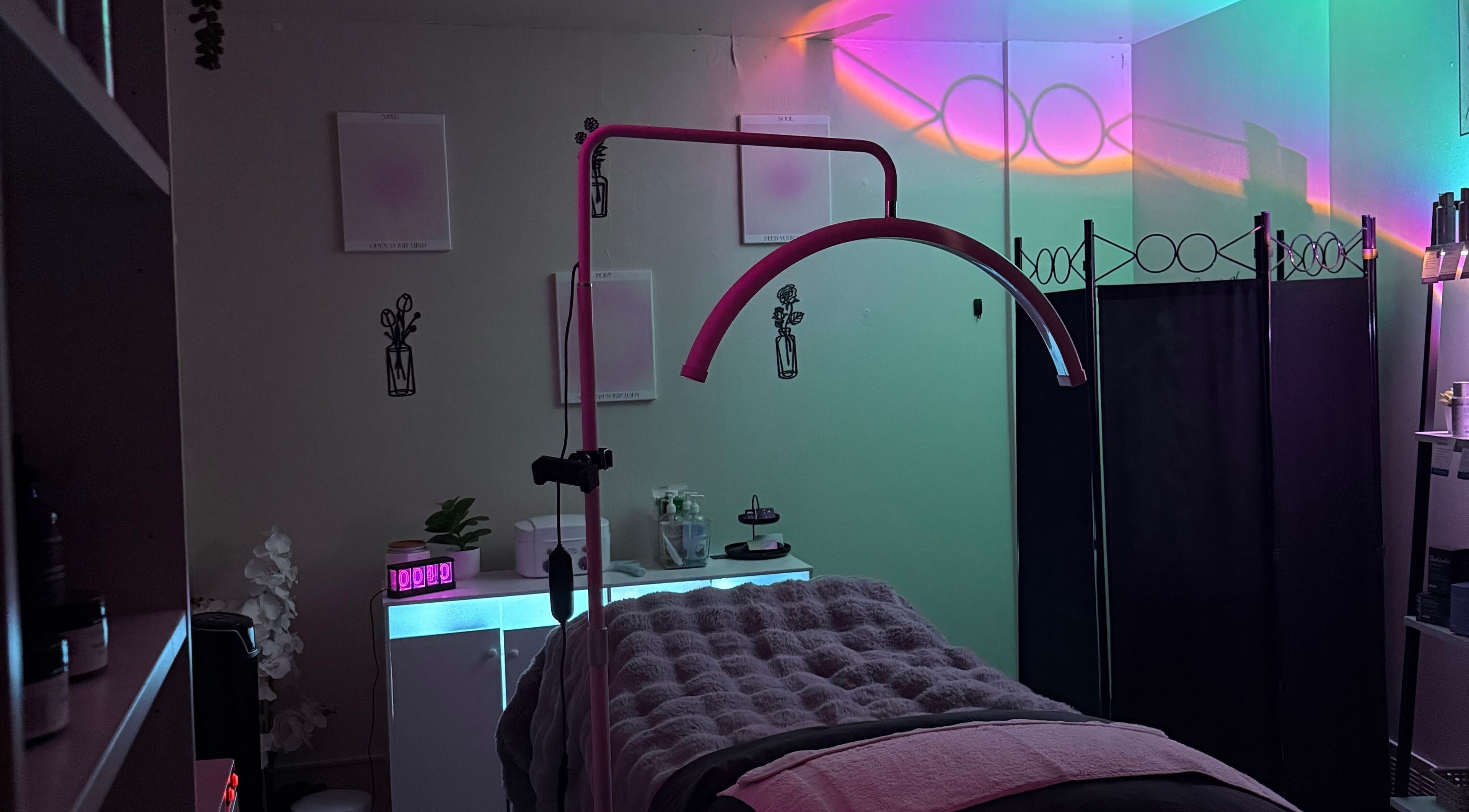 Relaxing treatment room at Timeless Glow Aesthetics, Kenosha, Wisconsin, US with ambient lighting and cozy decor.