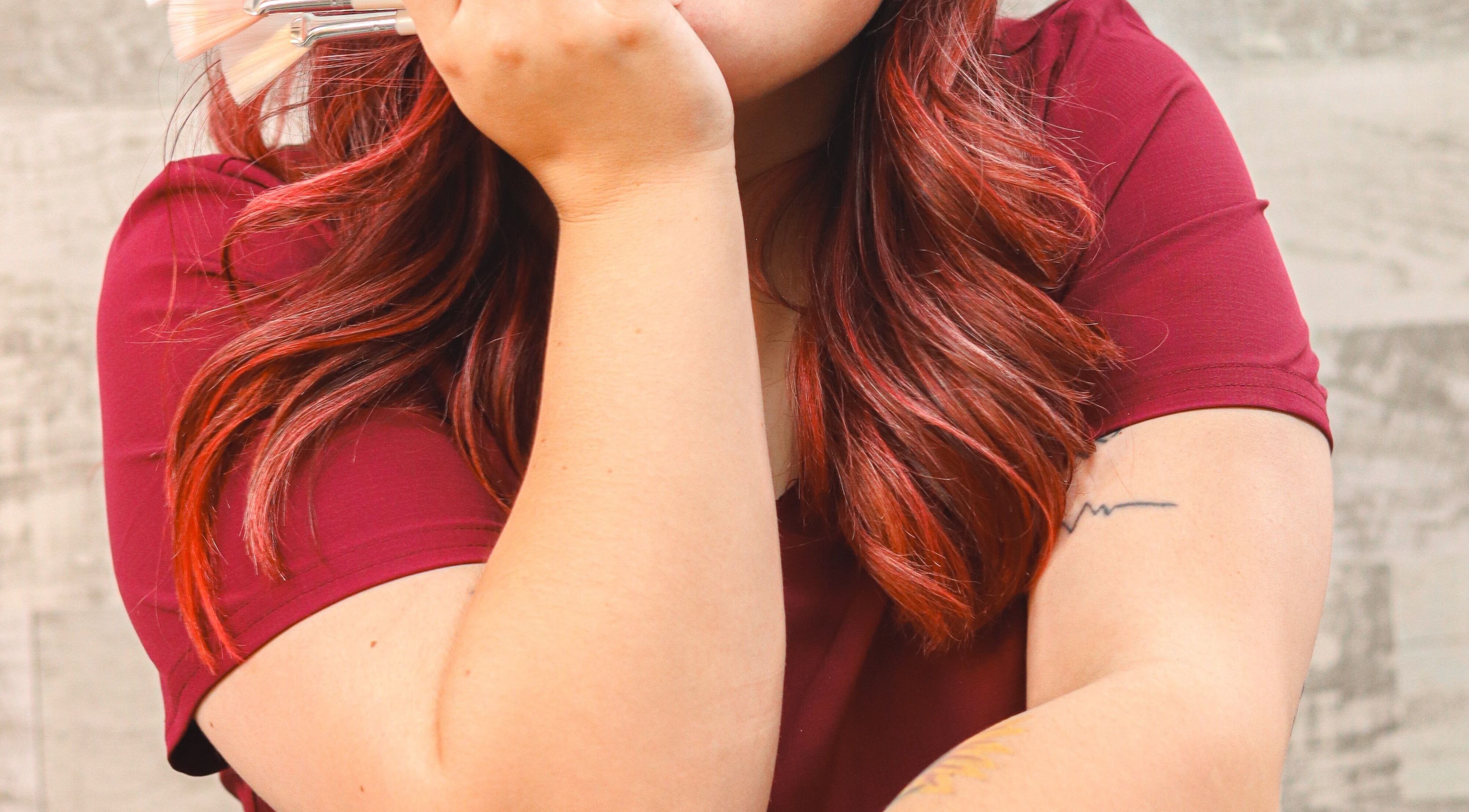 Makeup artist with brushes at Timeless Glow Aesthetics in Kenosha, Wisconsin, US, enhancing natural beauty.