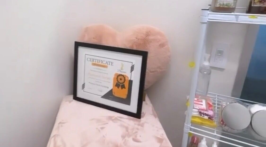 Certificate on pink cushion at Dyamond Sculpted, Rancho Cucamonga, California, US, showcasing prestige and comfort.