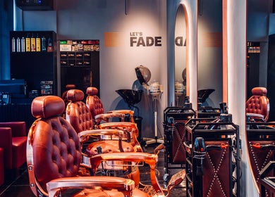 Modern salon interior at Let's Fade, Dubai, Dubai, AE, featuring luxurious leather chairs and styling stations.