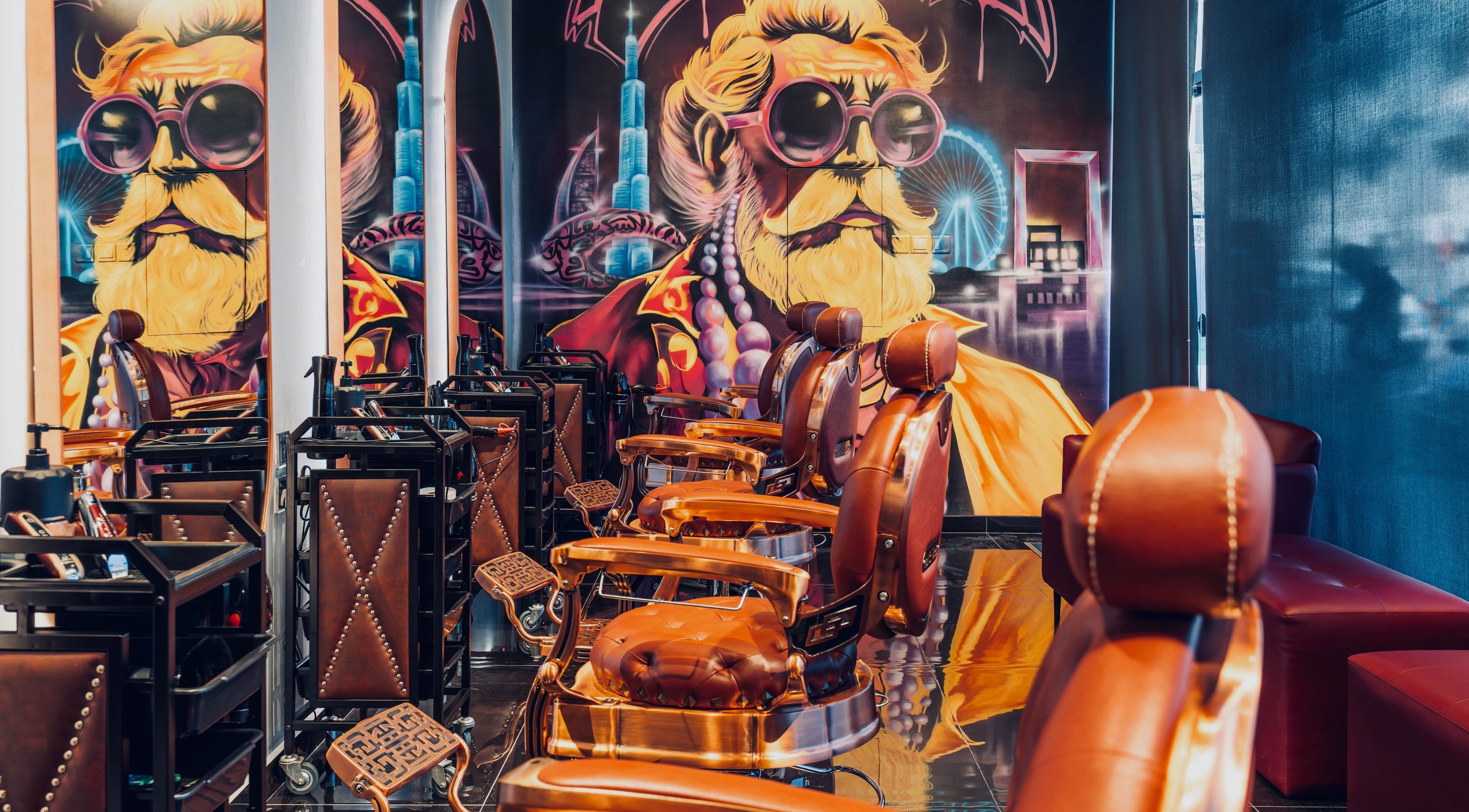 Stylish barber chairs at Let's Fade Bespoke, Dubai, Dubai, AE, with vibrant wall art.