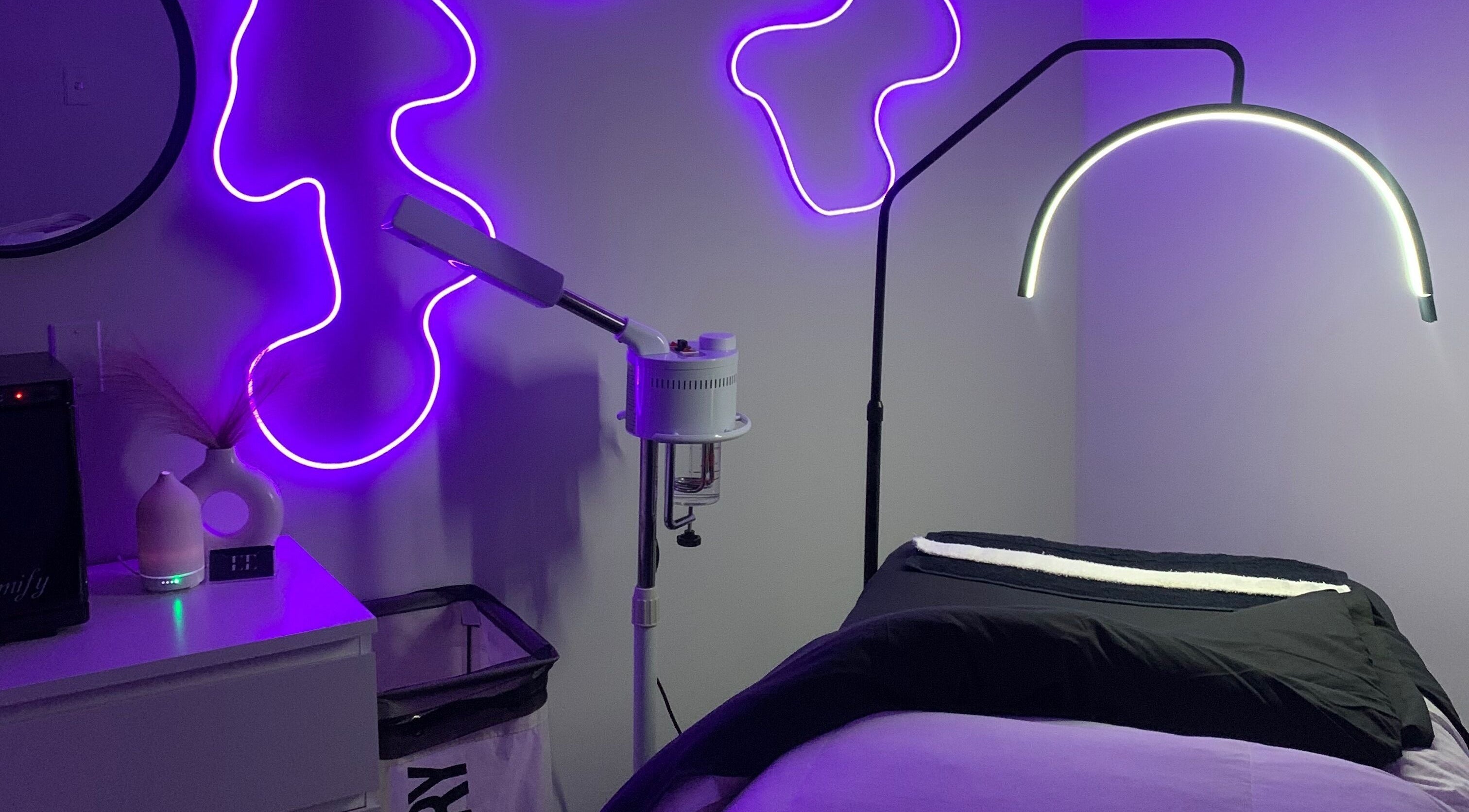 Relaxing treatment room with neon lights at Eminence Esthetics in Mississauga, Ontario, CA.