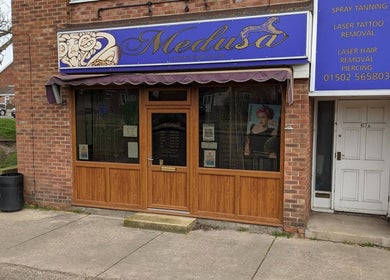 Entrance of Medusa's Hair and Beauty Salon in Lowestoft, England, GB, showcasing its elegant signage.