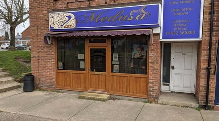 Entrance of Medusa's Hair and Beauty Salon in Lowestoft, England, GB, showcasing its elegant signage.