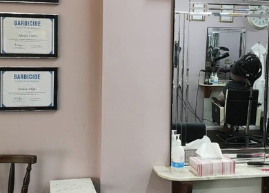 Interior of Medusa's Hair and Beauty Salon, Lowestoft, England, showcasing hair treatment and certificates.