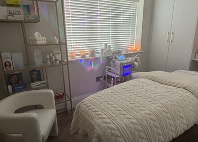 Relaxing treatment room at Shaped Co., Westhoughton, England, GB with plush bedding and ambient lighting.