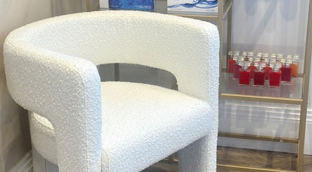 Elegant white chair and products at Shaped Co., Westhoughton, England, GB. A touch of luxury in wellness.