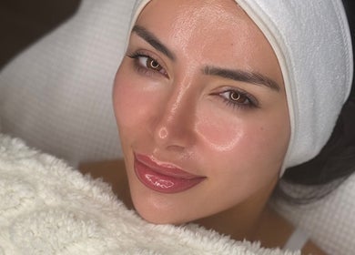 Relaxed woman enjoying facial treatment at Shaped Co., Westhoughton, England, GB for glowing skin.