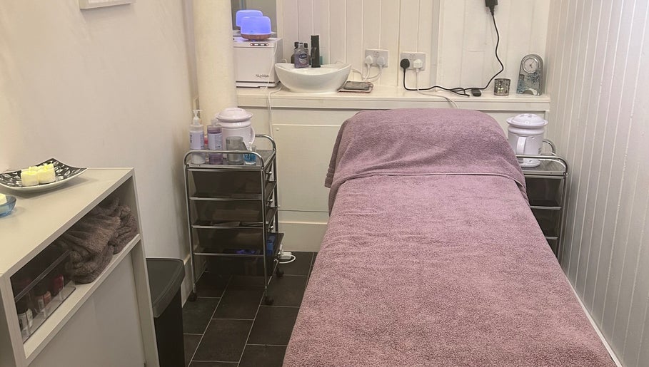 Cozy treatment room at Beauty by Lynsey in Elgin, Scotland, GB with massage table and calming decor.
