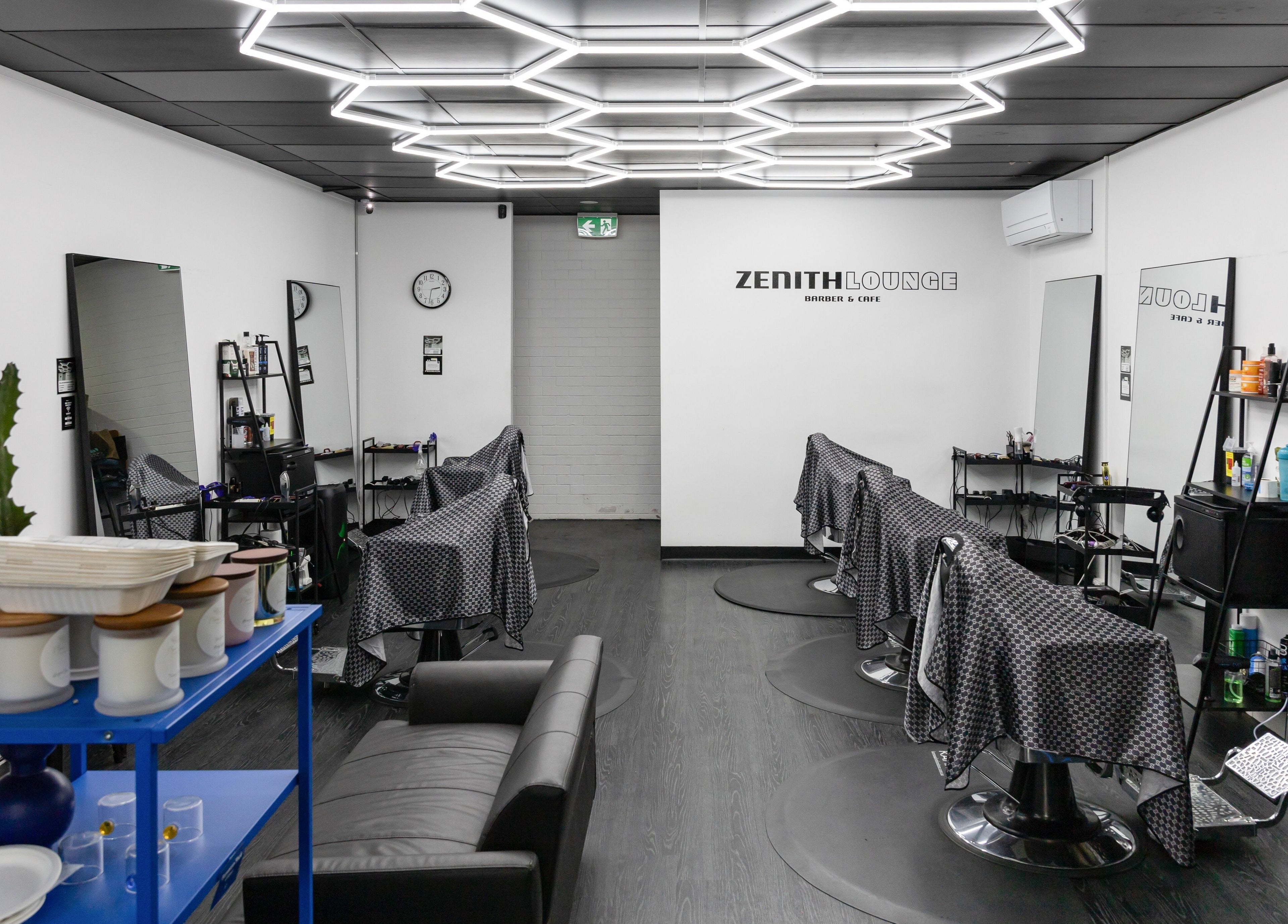 Chic interior of Zenith Lounge Barber & Cafe Tarragindi, in Tarragindi, QLD, AU, featuring modern decor and seating.