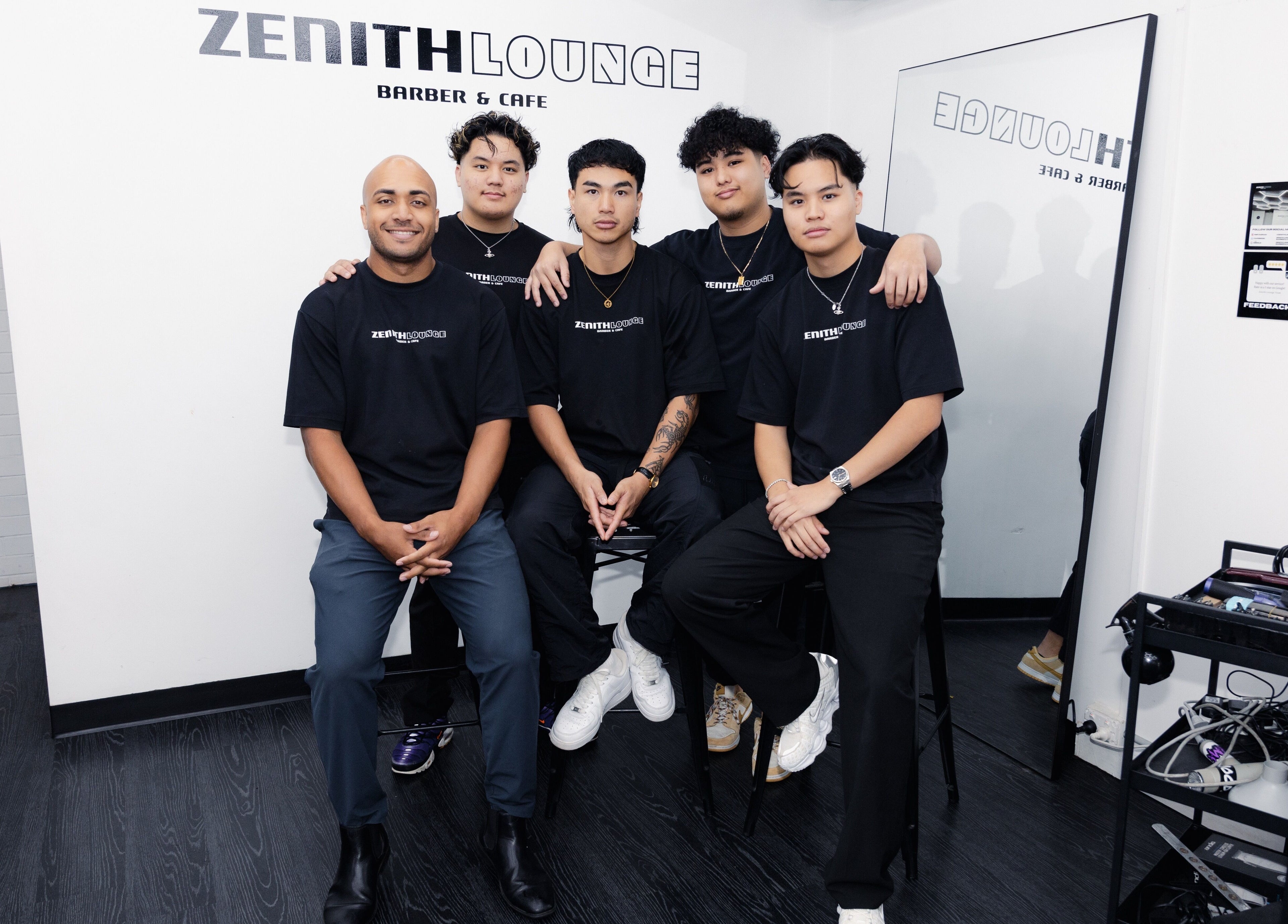 Staff at Zenith Lounge Barber & Cafe Tarragindi in Tarragindi, QLD, AU smiling for a group photo indoors.