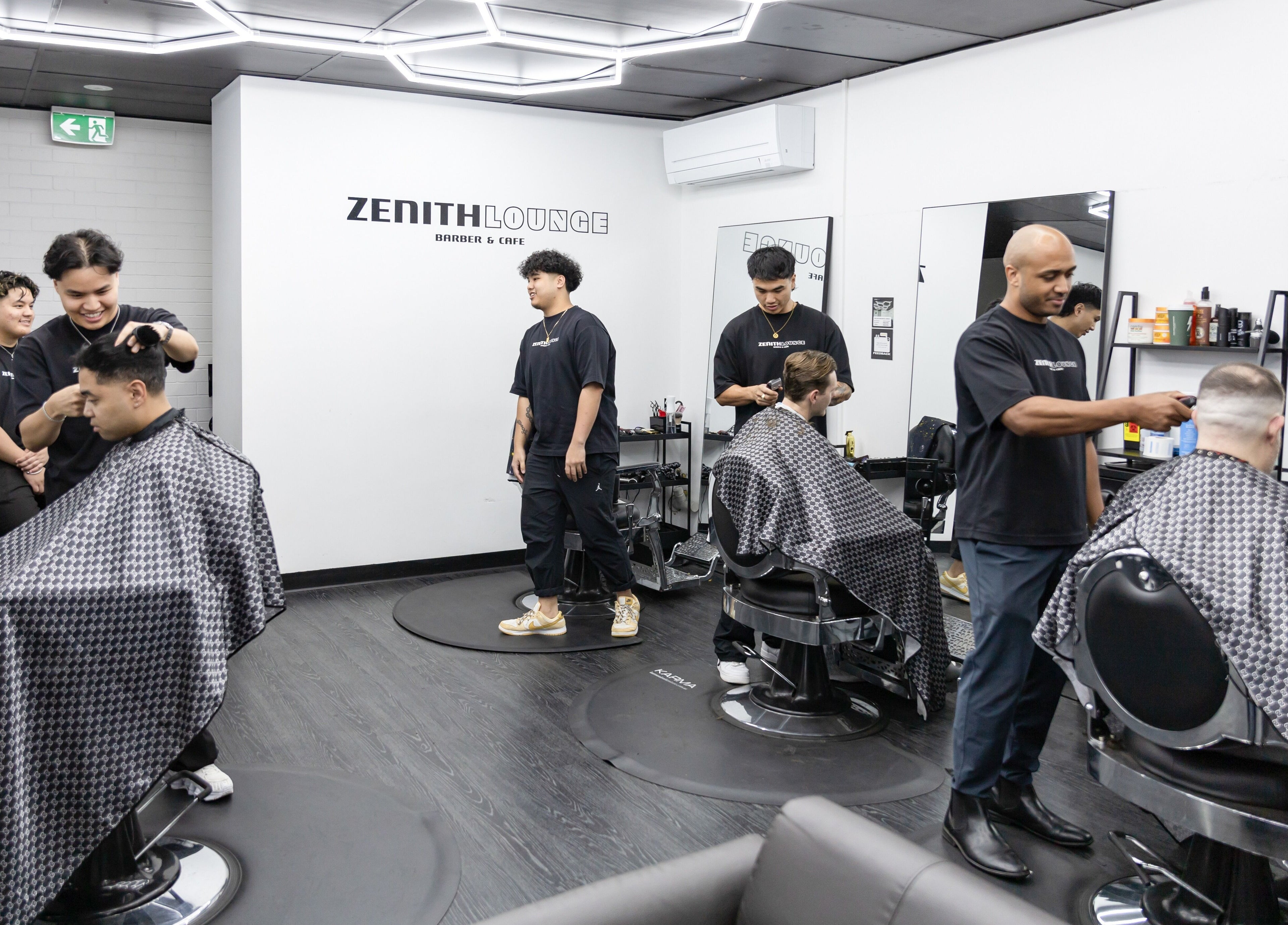 Stylish barbers in action at Zenith Lounge Barber & Cafe Tarragindi, QLD, AU, offering grooming services.