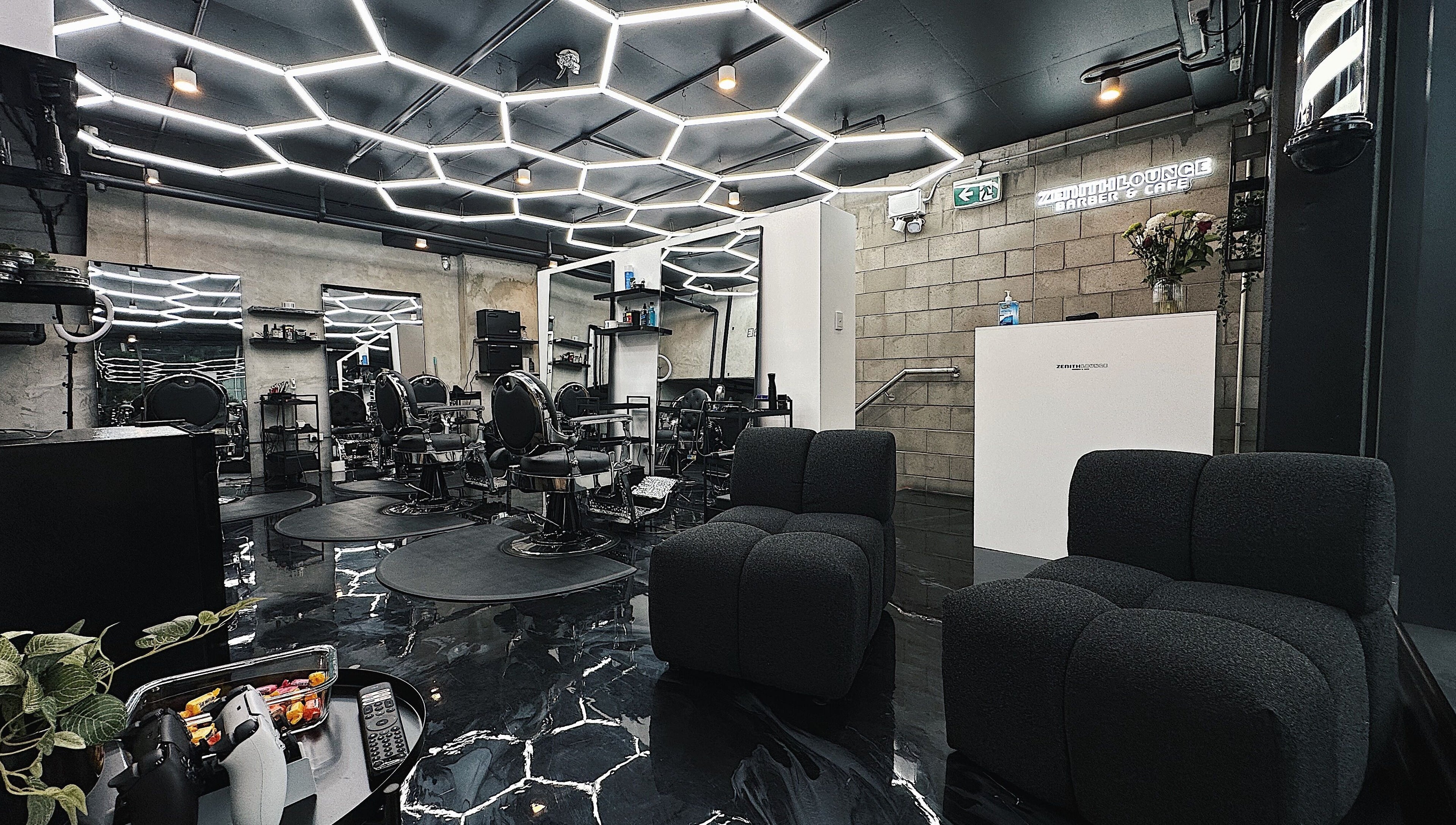 Modern interior of Zenith Lounge Barber & Cafe Kelvin Grove, Queensland, AU highlighting sleek seating and design.