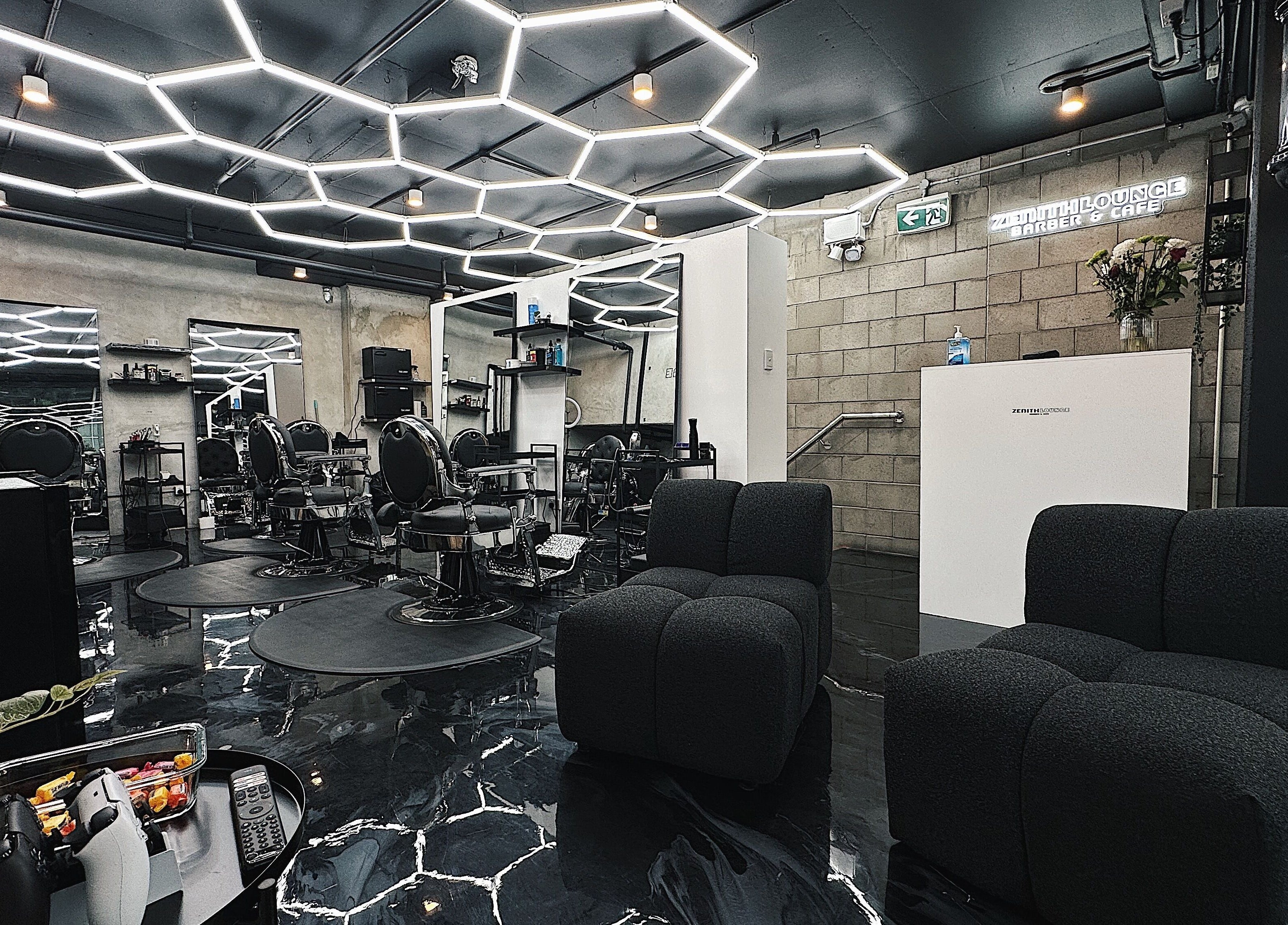 Modern interior of Zenith Lounge Barber & Cafe Kelvin Grove, Queensland, AU highlighting sleek seating and design.