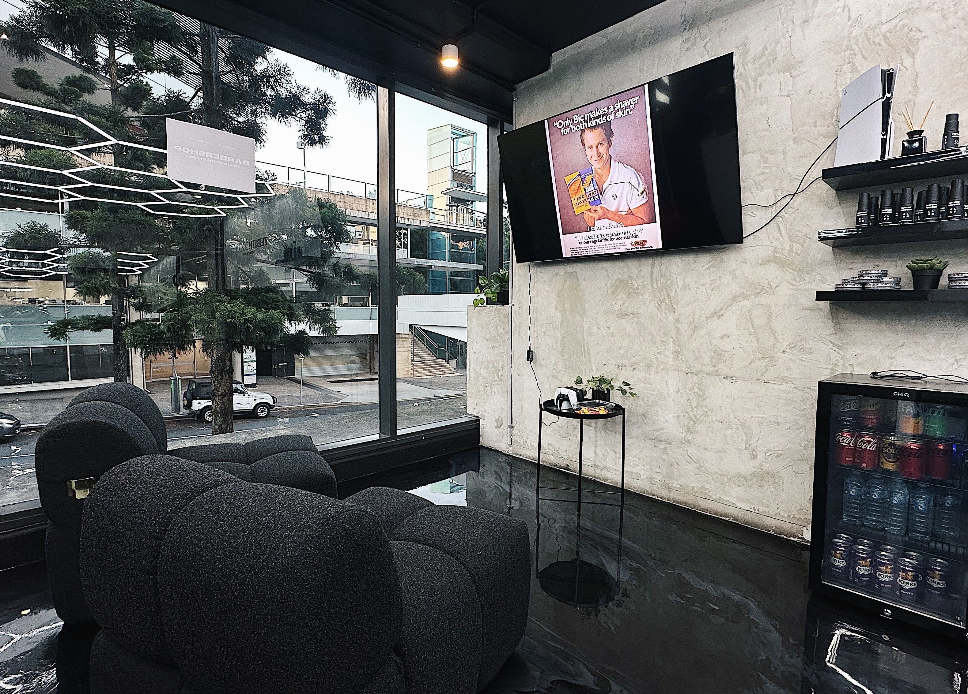 Chic interior of Zenith Lounge Barber & Cafe Kelvin Grove, featuring modern decor and street view in Queensland, AU.