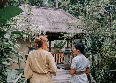 Visitors walking on the tranquil pathway at Mahamaya Spa at Ubud Nyuh Bali Resort, Bali, Bali, ID.