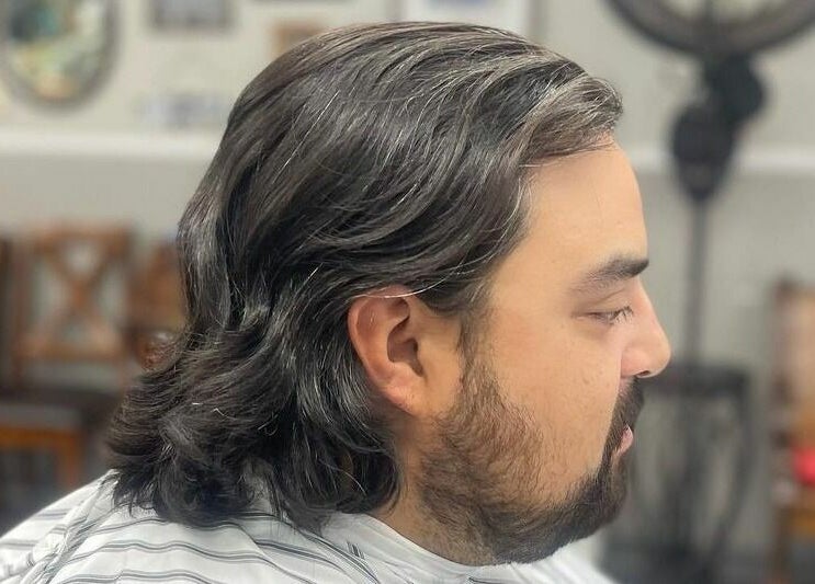 Side view of a man with styled hair at CDO Barbershop in Tucson, Arizona, US.