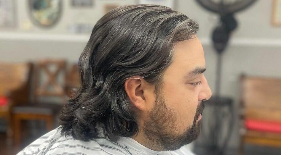 Side view of a man with styled hair at CDO Barbershop in Tucson, Arizona, US.