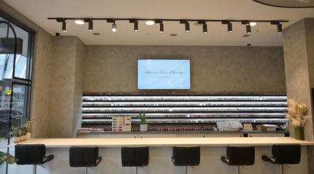 Interior of NATURAL NAILS AND BEAUTY FRANKSTON in Melbourne, Victoria, AU with nail polish display and seating.