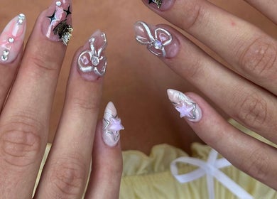Intricate 3D nail art at NAILSUNSHINE, Bali, Bali, ID, featuring stars and bows.