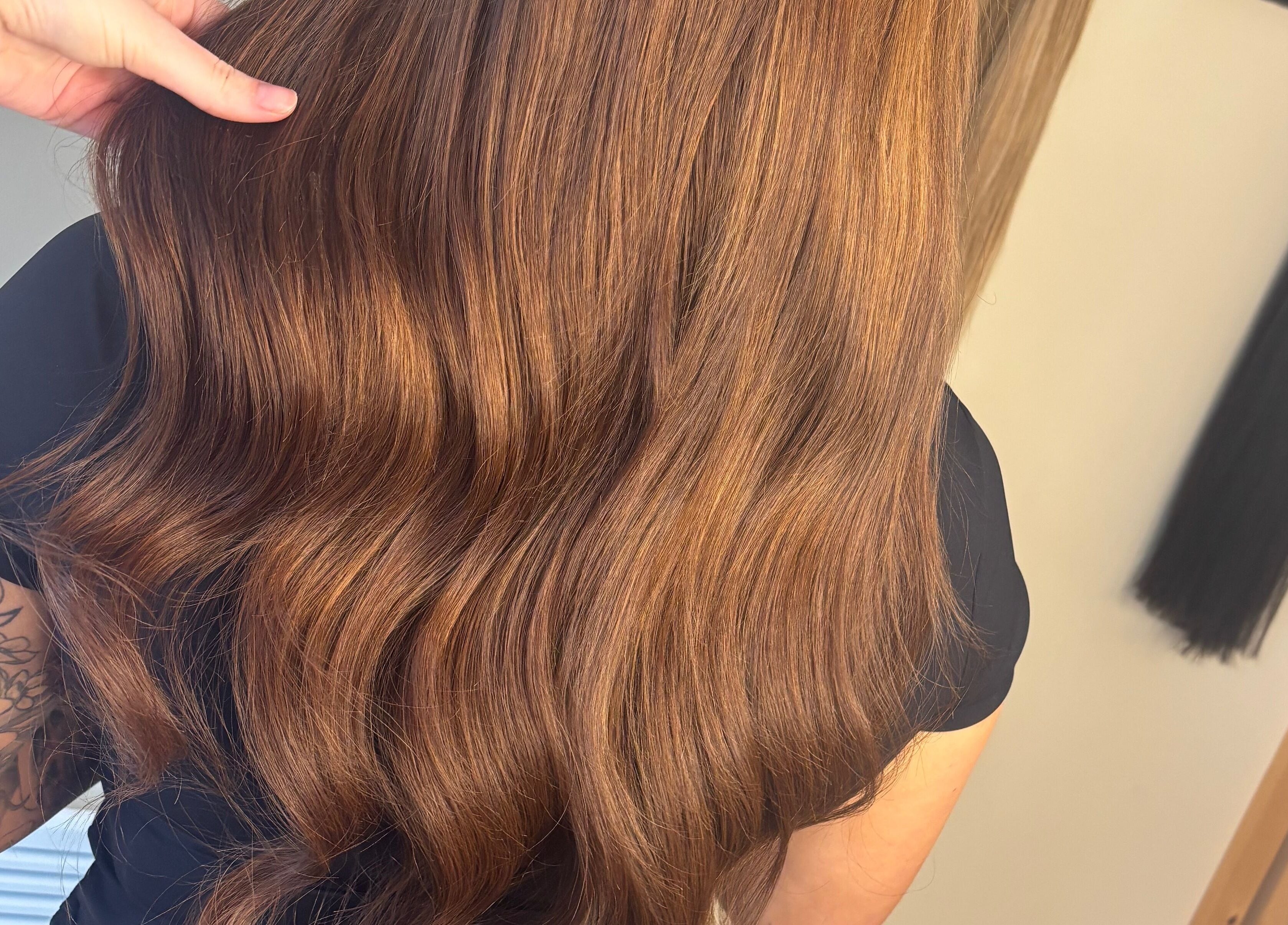 Shiny brown hair styled in waves at Sweetie Hairdressing, Blythe Bridge, England, GB.