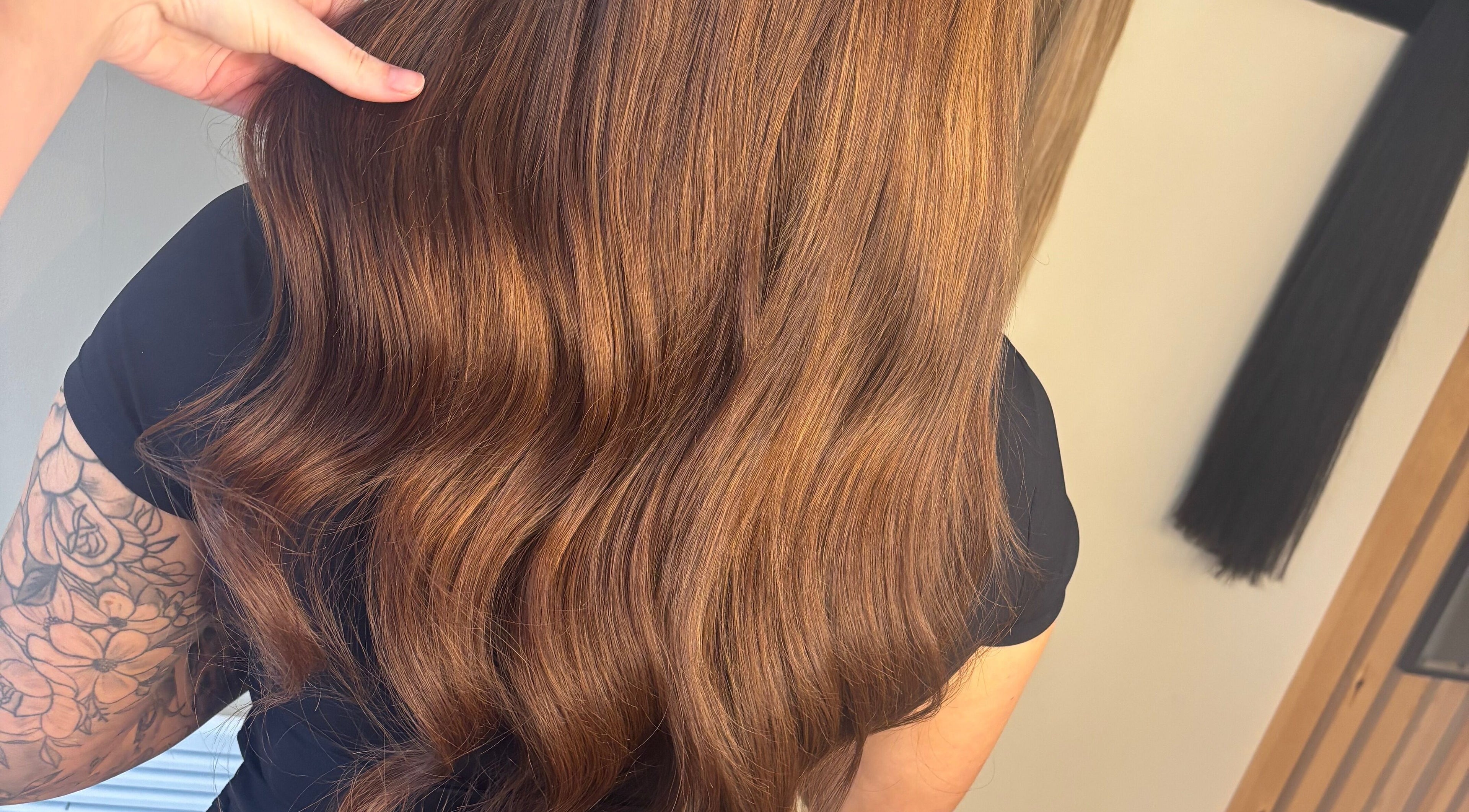 Shiny brown hair styled in waves at Sweetie Hairdressing, Blythe Bridge, England, GB.