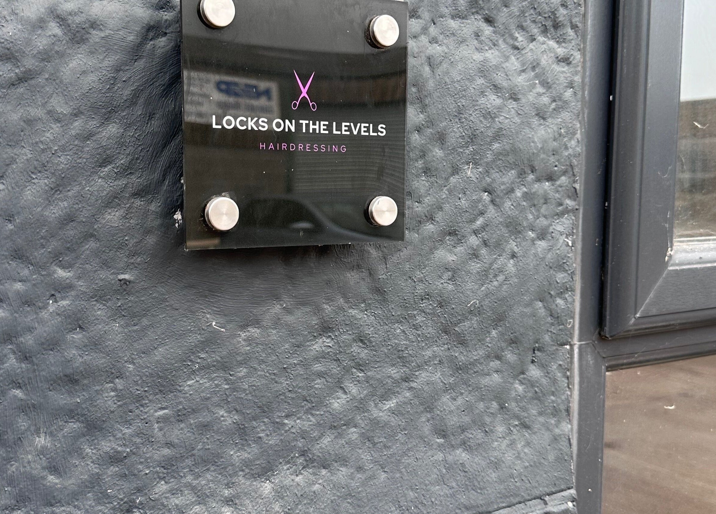Sign of Locks on the Levels hairdressing salon, Middlezoy, England, GB.
